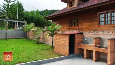 a house with a brick exterior and a yard at La Casa de Darío - Hospedaje y Casa de Campo en Oxapampa con Piscina in Oxapampa