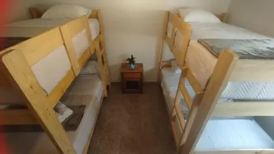 a small room with two bunk beds and a table at Magdalena del Mar, mejor ubicación imposible in Lima