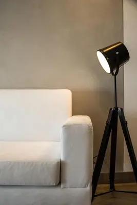 a lamp sitting next to a white couch next to a table at Sahara Sunset 2BR by Geko in Lima