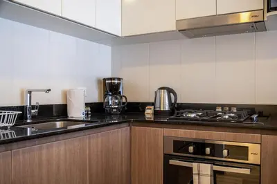 a kitchen with a sink and a stove at Sahara Sunset 2BR by Geko in Lima