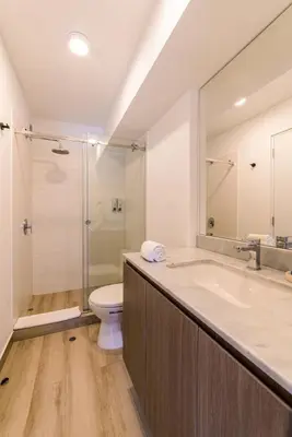 a bathroom with a tub and a toilet and a shower at Sahara Sunset 2BR by Geko in Lima