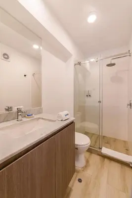 a bathroom with a sink and a toilet and a shower at Sahara Sunset 2BR by Geko in Lima