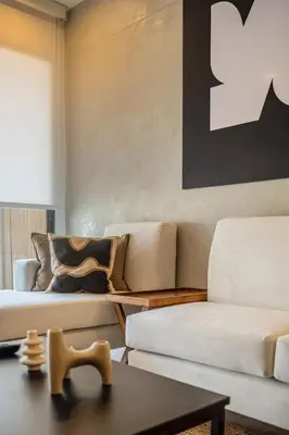 a living room with two white couches and a table at Sahara Sunset 2BR by Geko in Lima