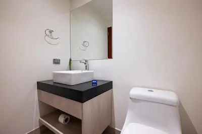 a bathroom with a white toilet and a sink at Taurus 2BR by Geko in Lima