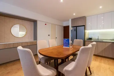 a kitchen and dining room with a wooden table and chairs at Premium 2BR Apartment Steps from Kennedy Park in Lima