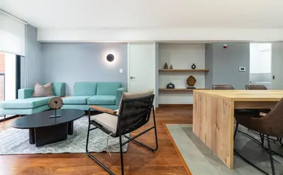 a living room with a couch and a table at Premium 2BR Apartment Steps from Kennedy Park in Lima