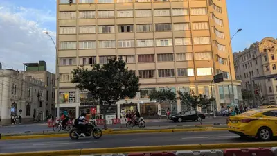 a group of people riding bikes down a city street at Amplia habitación en centro de Lima in Lima