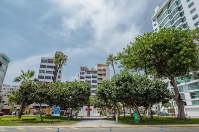 a park with trees in front of tall buildings at Manuel Tovar Apartment in Miraflores 1 BDR in Lima