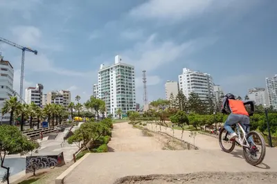 a person riding a bike in a park at Manuel Tovar Apartment in Miraflores 1 BDR in Lima