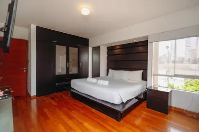 a bedroom with a large white bed and a window at Manuel Tovar Apartment in Miraflores 1 BDR in Lima