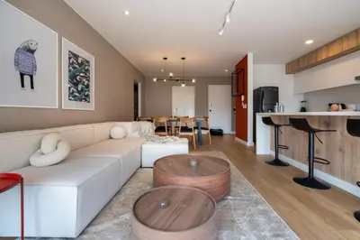 a living room with a white couch and a table at Francia by Geko in Lima
