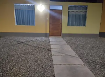a room with a door and a floor with gravel at Acogedora casa en ICA - PERU in Ica