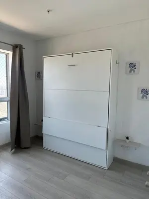 a white refrigerator in a room with a window at Loft Ale Piso 22 in Lima