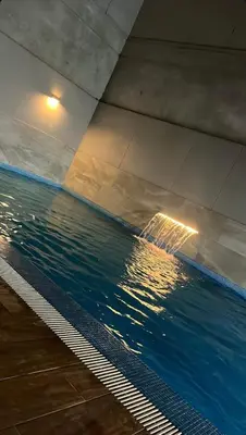 a swimming pool with water underneath a bridge at Loft Ale Piso 22 in Lima