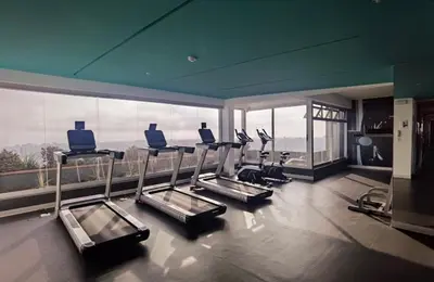 a gym with cardio equipment and a large window at Loft Ale Piso 22 in Lima