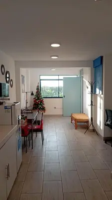 a living room with a christmas tree and a table at Casa Sunampe Chincha - 2do Piso in Sunampe