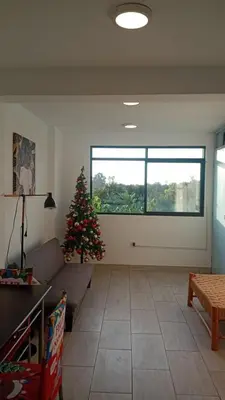 a living room with a christmas tree and a couch at Casa Sunampe Chincha - 2do Piso in Sunampe
