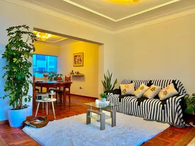a living room with a couch and a table at Casa Raíz Cusco in Cusco