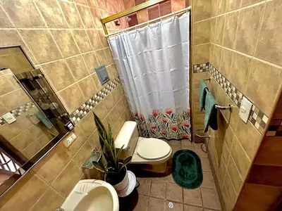 a bathroom with a toilet and a shower and a sink at Casa Raíz Cusco in Cusco