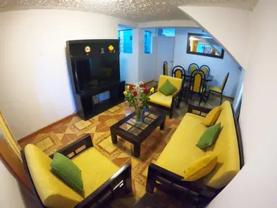 an aerial view of a living room with yellow furniture at Ankay House in Cusco
