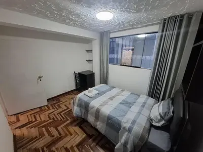 a small bedroom with a bed and a window at Ankay House in Cusco