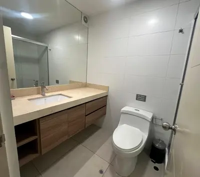 a bathroom with a toilet and a sink and a mirror at Pardo Miraflores Apartment - Aparts 4 Days in Lima