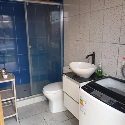 a bathroom with a sink and a toilet and a shower at casa de playa en lurin con piscina y parrilla in La Planicie