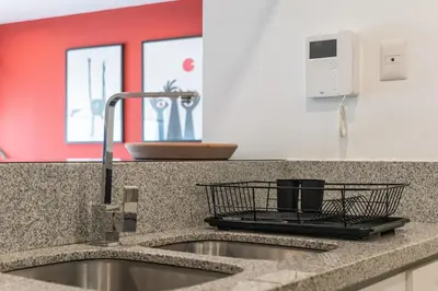 a kitchen counter top with a sink and aounter at Mezcal 1BR by Geko in Lima