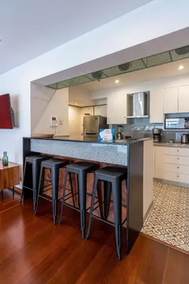 a kitchen with a large counter with stools at Mezcal 1BR by Geko in Lima
