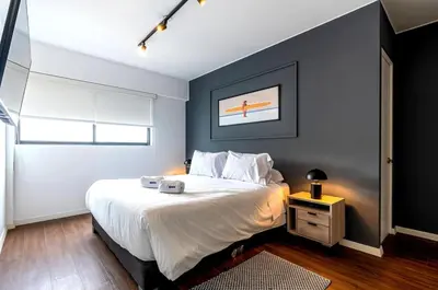 a bedroom with a large white bed and a window at Dubrovnik 2BR by Geko in Lima