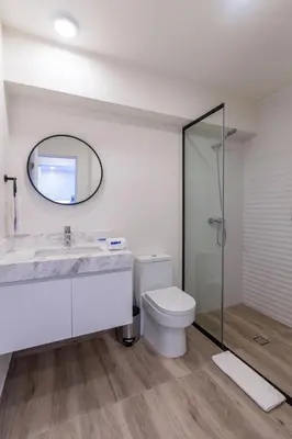 a bathroom with a toilet and a sink and a mirror at Samoa 1BR by Geko in Lima