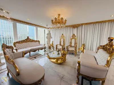 a living room with gold furniture and a chandelier at El Palacio del Rey in Lima