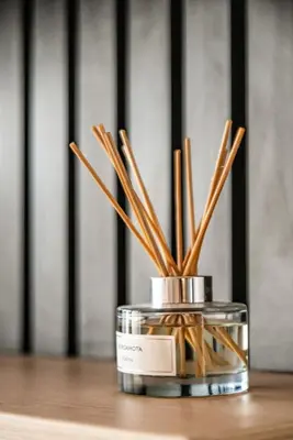 a glass jar with wooden sticks in it on a table at Vince City 1BR by Geko in Lima