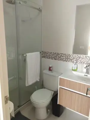 a bathroom with a toilet and a shower and a sink at Apartamento en San Miguel hermosa vista al mar in Lima