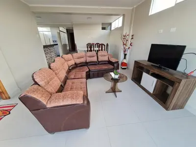 a living room with a couch and a flat screen tv at apartment MAGIC in Ayacucho