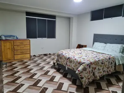 a bedroom with a bed and a dresser in it at apartment MAGIC in Ayacucho
