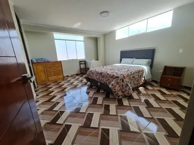 a bedroom with a bed and a wooden floor at apartment MAGIC in Ayacucho