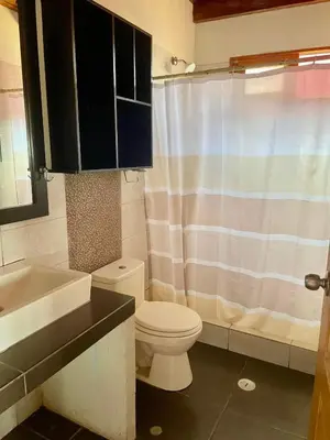 a bathroom with a toilet and a sink and a shower at Casa de playa en Wakama in San Vicente de Cañete