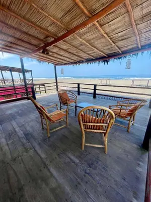 a group of chairs sitting on a pier near the beach at Casa de playa en Wakama in San Vicente de Cañete