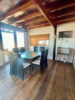 a dining room with a table and chairs at Casa de playa en Wakama in San Vicente de Cañete