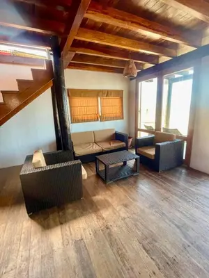 a living room with two couches and a table at Casa de playa en Wakama in San Vicente de Cañete
