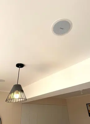 a light hanging from a ceiling with a light fixture at Céntrico y acogedor apartamento en Lince in Lima