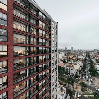 an apartment building with balconies and a city at Céntrico y acogedor apartamento en Lince in Lima