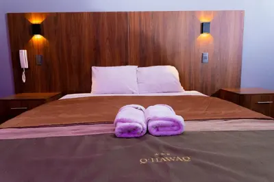 a bed with purple towels on top of it at Hotel Qhawaq Huancayo in Huancayo