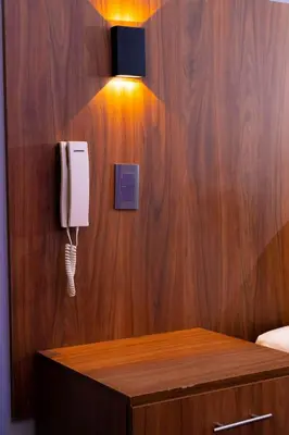 a room with a phone on a wooden wall at Hotel Qhawaq Huancayo in Huancayo