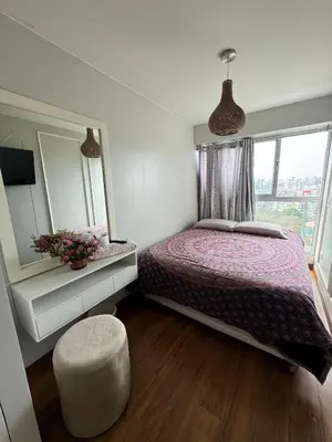 a bedroom with a bed and a large window at Dupli naranjos in Lima