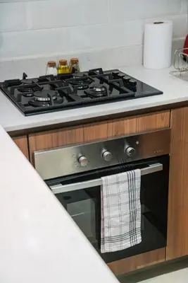 a stove top oven with a towel hanging from it at Zafira 1BR by Geko in Lima