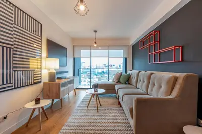 a living room with a couch and a table at Zafira 1BR by Geko in Lima