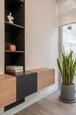 a room with a book shelf and a potted plant at Zebbra 1BR by Geko in Lima