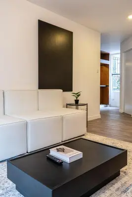 a living room with a white couch and a coffee table at Zebbra 1BR by Geko in Lima